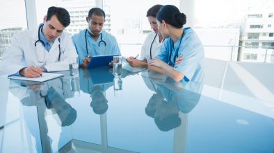 Marketing Tips: Group of young doctors in a meeting at hospital.