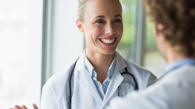 Beautiful doctor discussing with colleague in a promotional video.