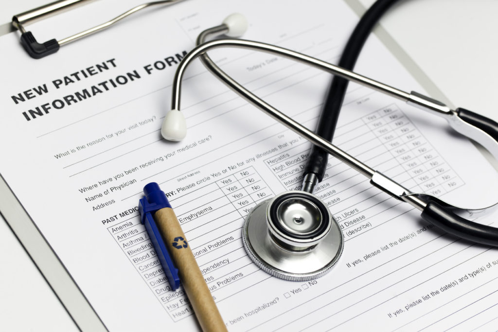 A clipboard with a form reading "New Patient Information" with a stethoscope and a pen, representing the cost to acquire a new patient lead.