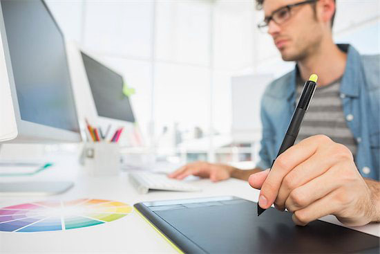 A designer works on a logo for a medical practice that has a strong sense of color to have an impact on their patients.